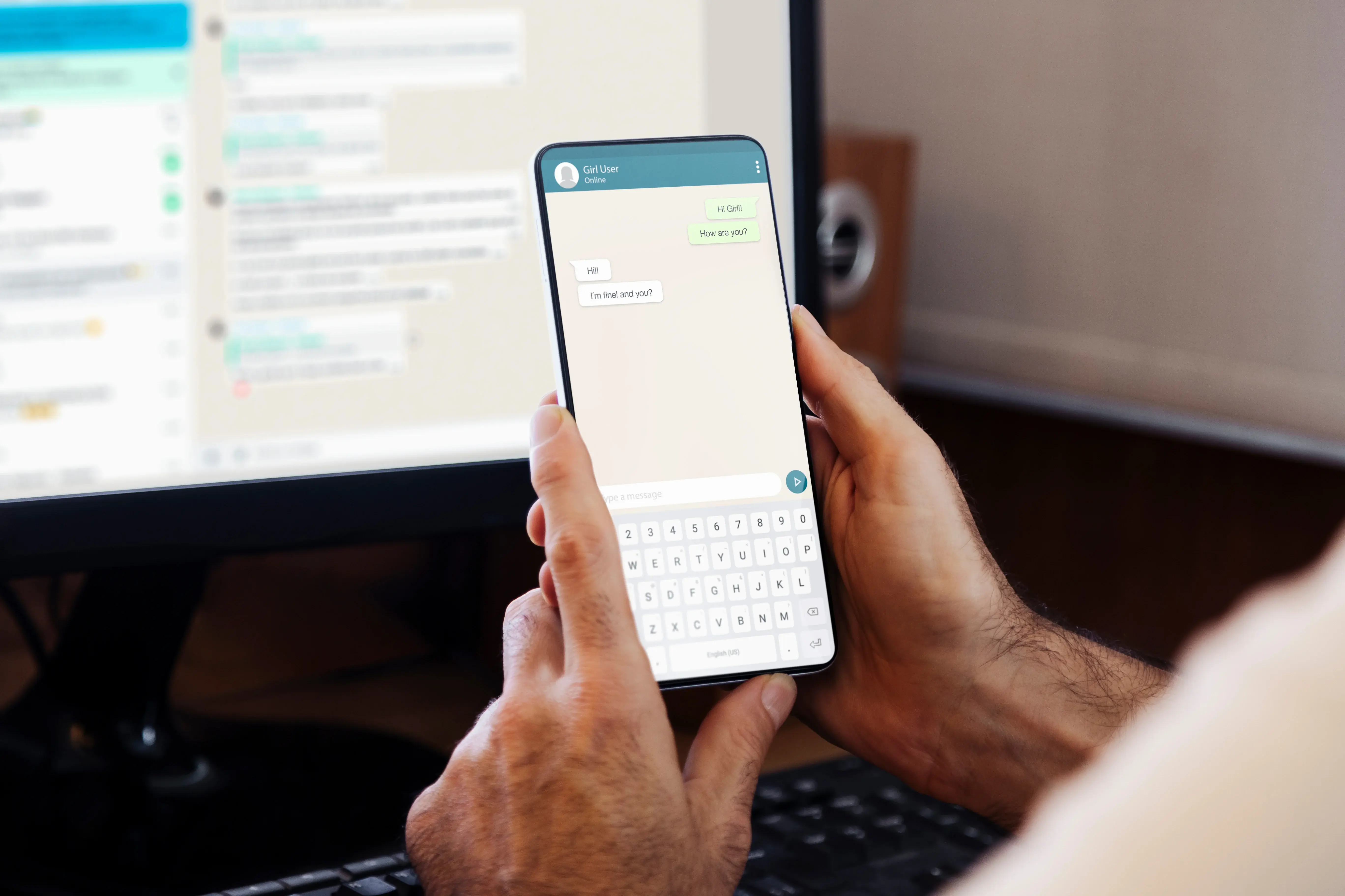 A person holding a smartphone and viewing a WhatsApp chat conversation, with similar messages displayed on a computer monitor in the background. This image represents the use of WhatsApp OSINT (Open Source Intelligence) techniques to gather digital evidence or investigative insights from chat communications across devices.